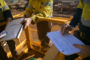 man holding clipboards working on Environmental, Process, and Safety Instrumentation